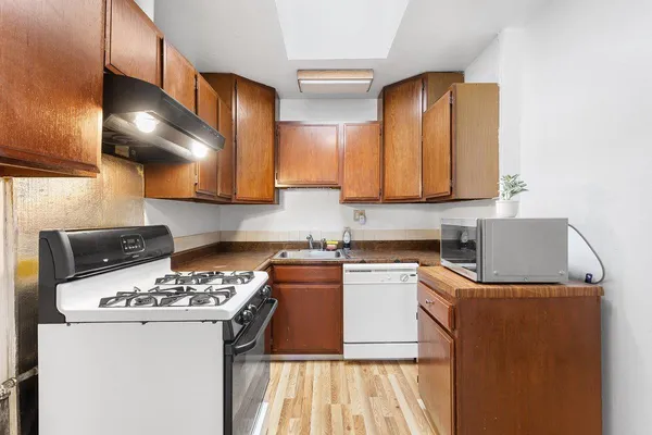 a kitchen with a sink a stove and cabinets