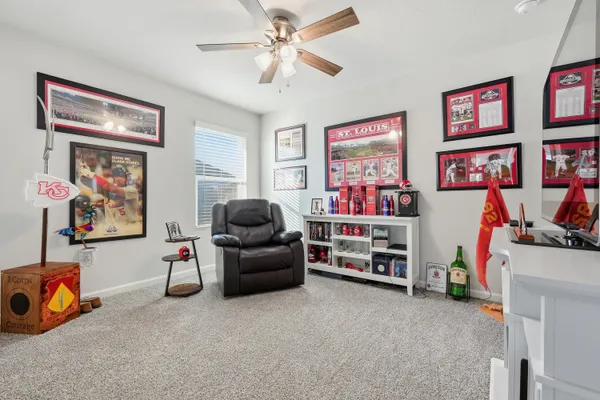 a kitchen with stainless steel appliances a sink stove refrigerator and white cabinets with wooden floor