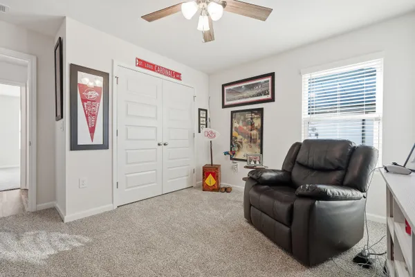 a kitchen with a sink dishwasher a refrigerator and white cabinets with wooden floor