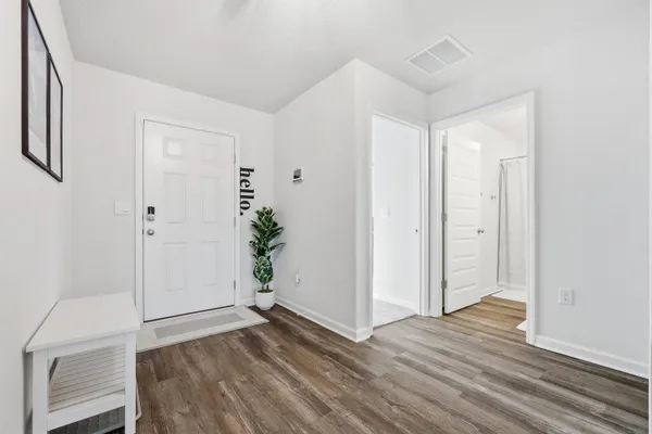 a living room with furniture and wooden floor