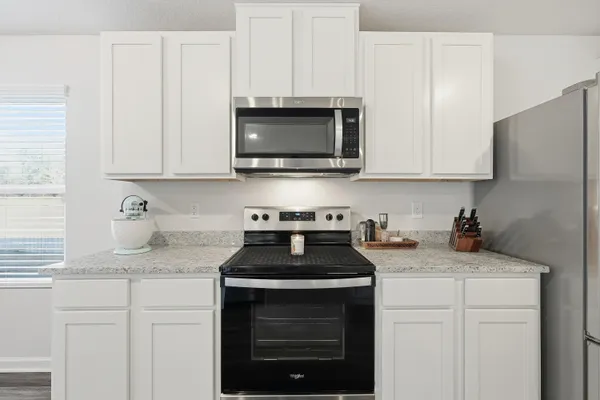 a en suite bathroom with a sink a large mirror and shower