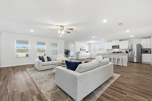 a bedroom with a bed and a chandelier fan