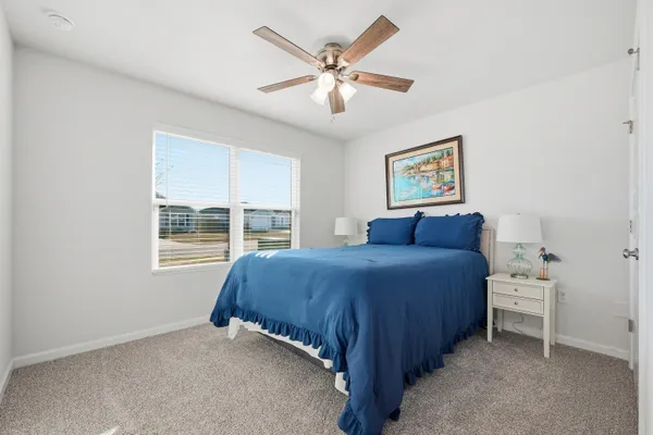 a kitchen with white cabinets appliances and wooden floor