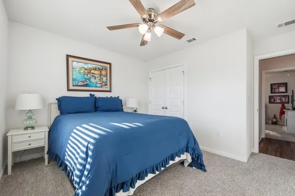 a kitchen with granite countertop white cabinets and a stove a sink