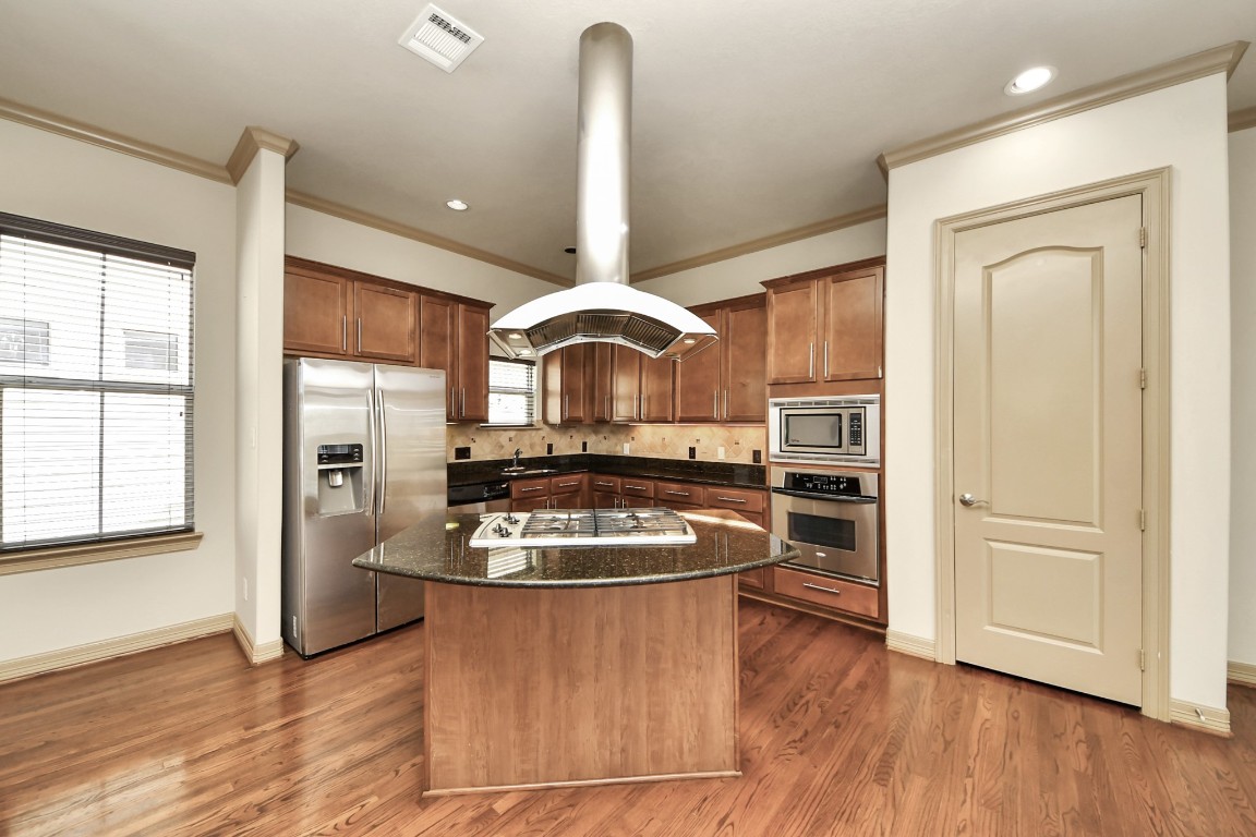 5711 Kiam Street Houston, TX 77007 - Photo 11 of 30 a kitchen with a refrigerator and a stove top oven