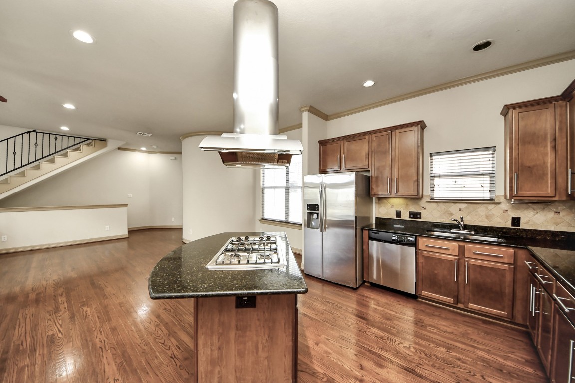 5711 Kiam Street Houston, TX 77007 - Photo 13 of 30 a kitchen with stainless steel appliances granite countertop a sink stove and refrigerator