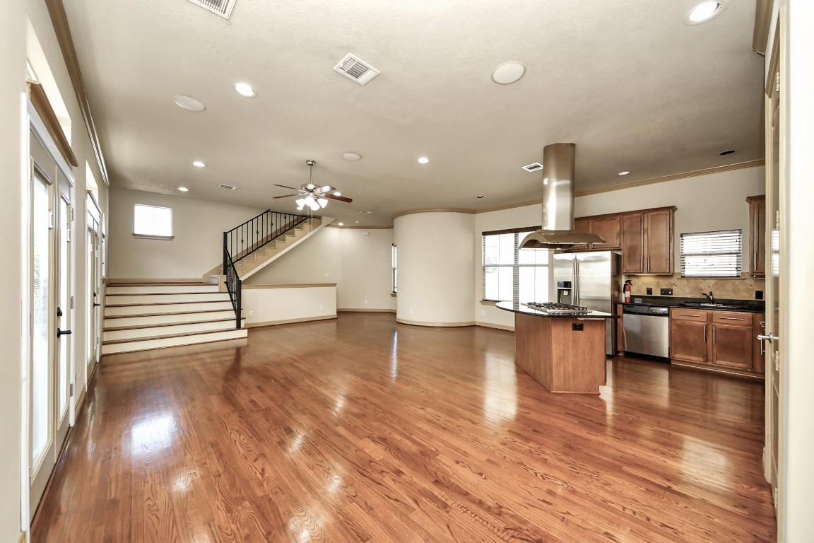 5711 Kiam Street Houston, TX 77007 - Photo 2 of 30 a view of a kitchen and dining room with wooden floor