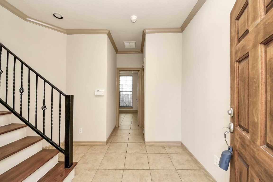 5711 Kiam Street Houston, TX 77007 - Photo 5 of 30 a view of a hallway with wooden floor and staircase