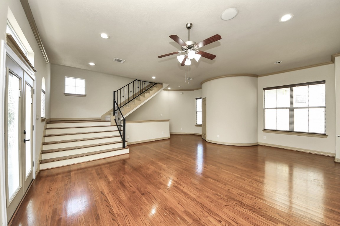 5711 Kiam Street Houston, TX 77007 - Photo 8 of 30 a view of an empty room with wooden floor and a window