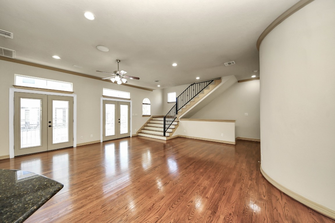 5711 Kiam Street Houston, TX 77007 - Photo 9 of 30 a view of an empty room with wooden floor and a window