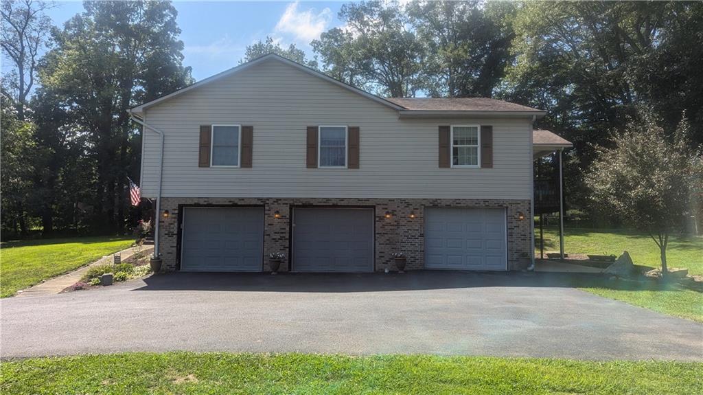 228 Reiber Road Renfrew, PA 16053 - Photo 5 of 25 a front view of a house with a yard and garage