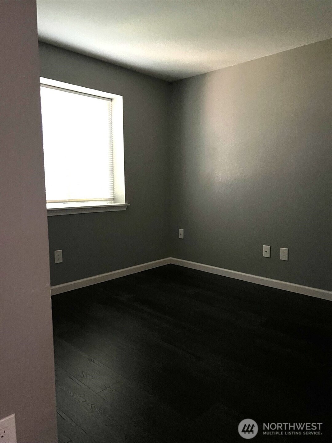 1124 Pinedrop Loop Southeast Olympia, WA 98513 - Photo 16 of 20 a view of an empty room with wooden floor and a window