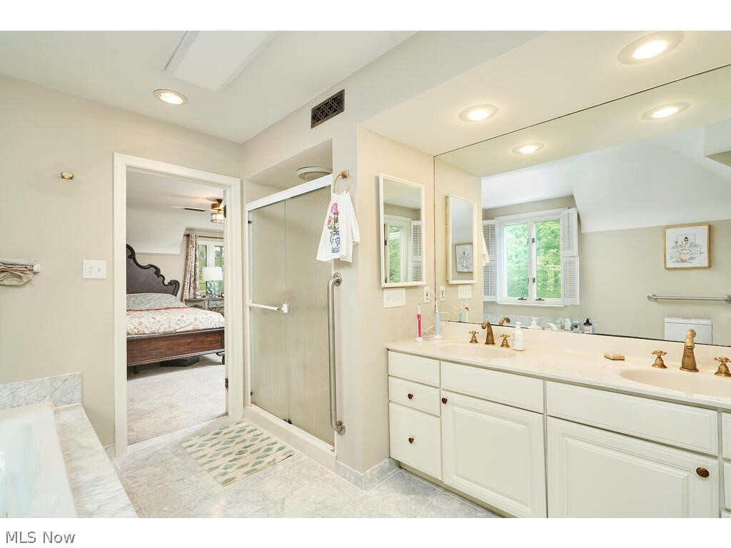 2253 Tinkham Road Akron, OH 44313 - Photo 19 of 31 Bathroom with tile flooring, ceiling fan, an enclosed shower, and double vanity