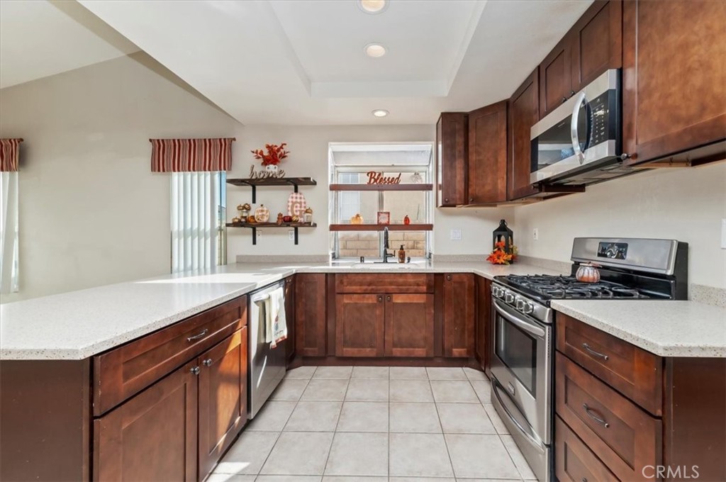 19966 Westerly Drive Riverside, CA 92508 - Photo 10 of 39 a kitchen with stainless steel appliances granite countertop a sink and stove top oven