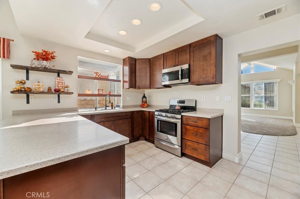 19966 Westerly Drive Riverside, CA 92508 - Photo 11 of 39 a kitchen with stainless steel appliances a stove sink and cabinets