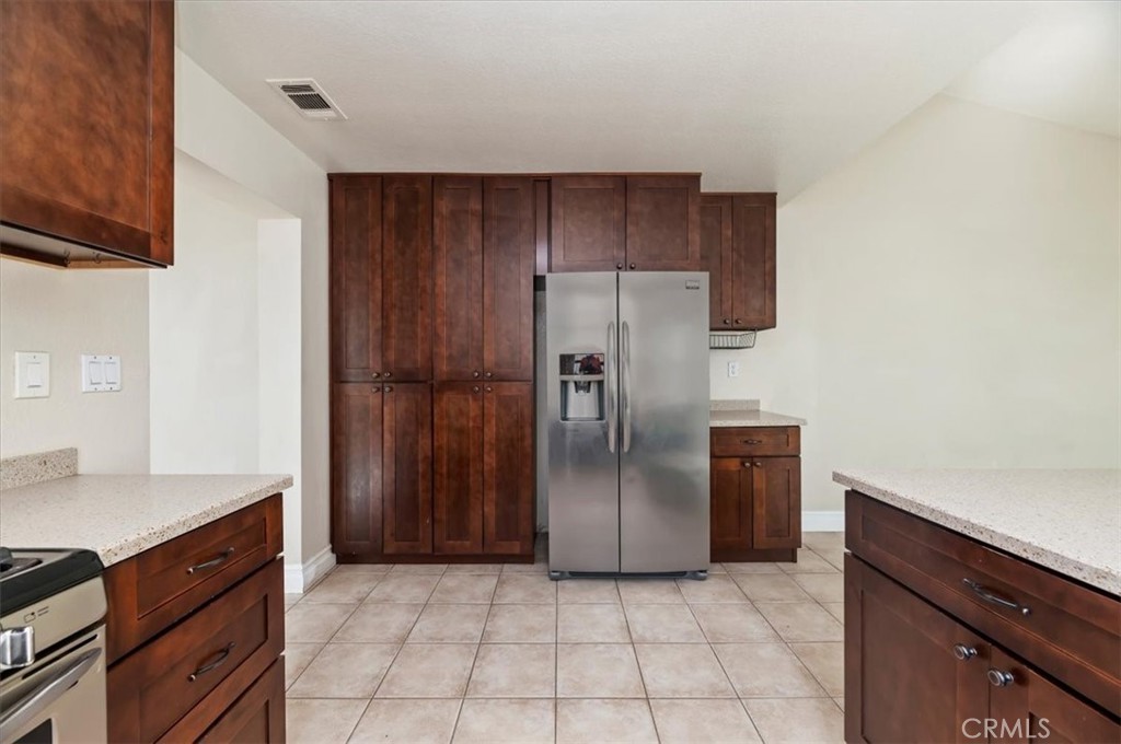 19966 Westerly Drive Riverside, CA 92508 - Photo 12 of 39 a kitchen with a refrigerator and cabinets