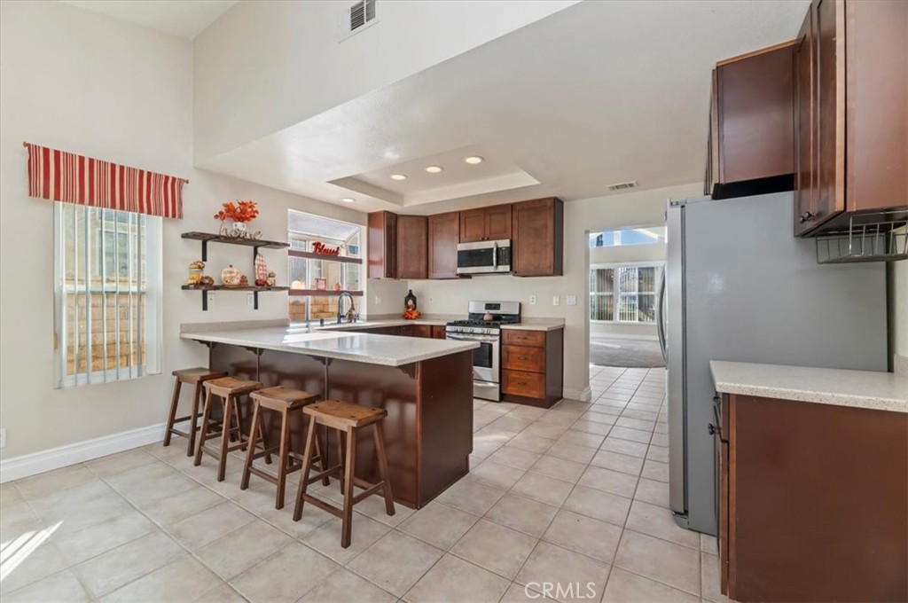 19966 Westerly Drive Riverside, CA 92508 - Photo 14 of 39 a kitchen with stainless steel appliances granite countertop a stove top oven a sink a counter top space and cabinets
