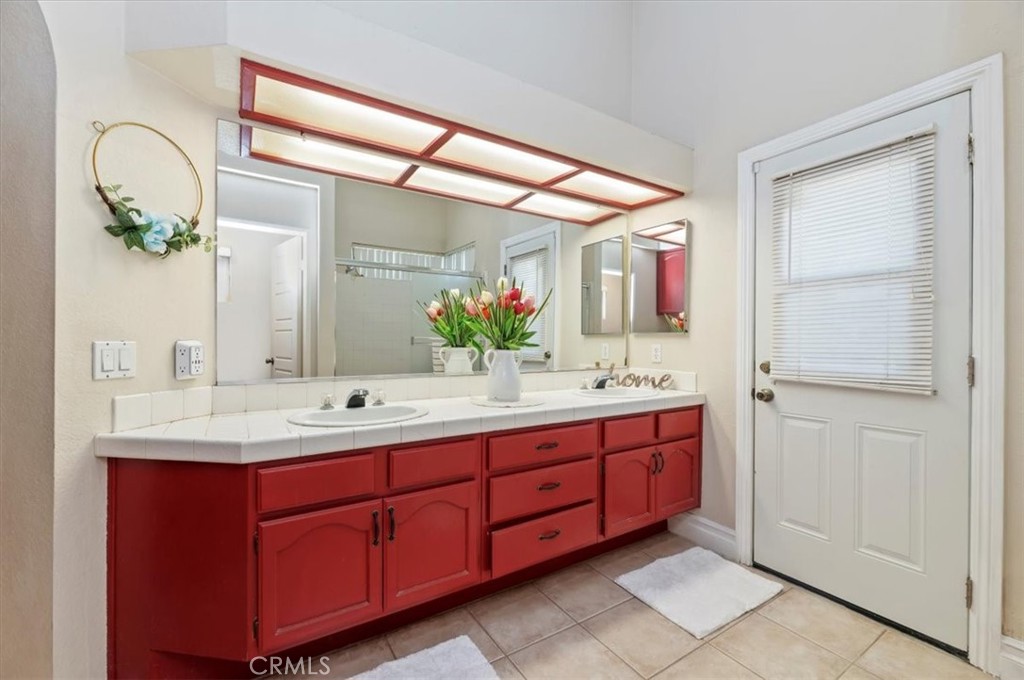 19966 Westerly Drive Riverside, CA 92508 - Photo 25 of 39 a bathroom with a double vanity sink and a mirror