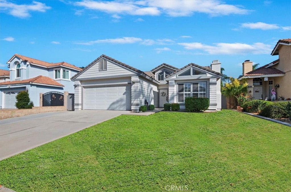 19966 Westerly Drive Riverside, CA 92508 - Photo 3 of 39 a front view of a house with a garden and yard