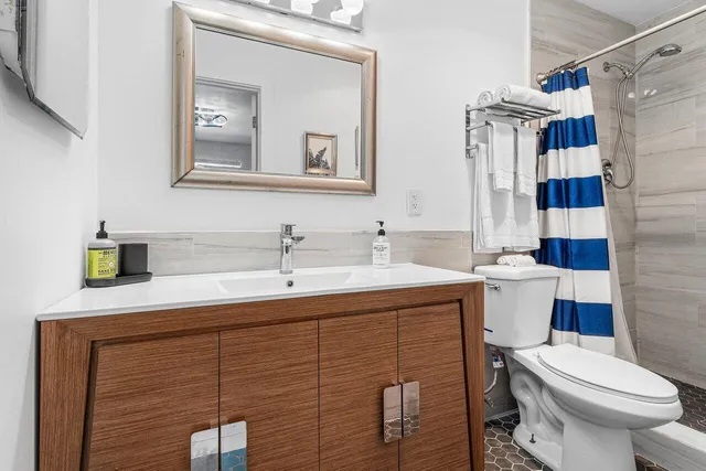 a bathroom with a sink toilet and shower