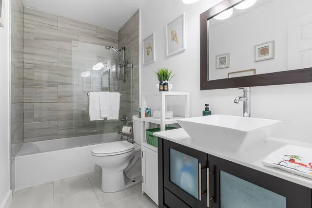 a bathroom with a sink toilet and shower