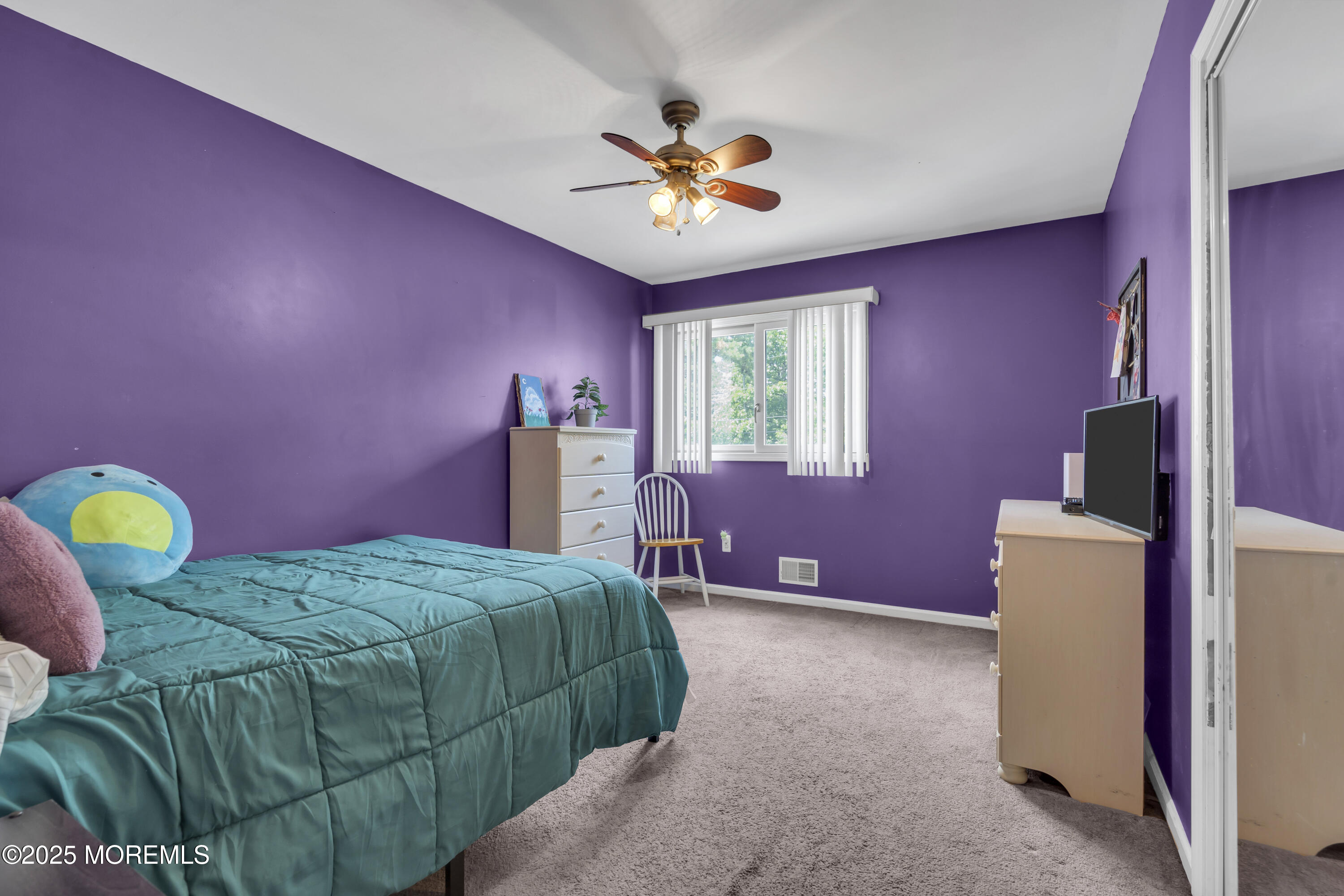 993 Sandy Circle Manahawkin, NJ 08050 - Photo 24 of 43 a bedroom with a bed and a chandelier