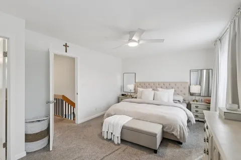 a spacious bedroom with a bed and a chandelier