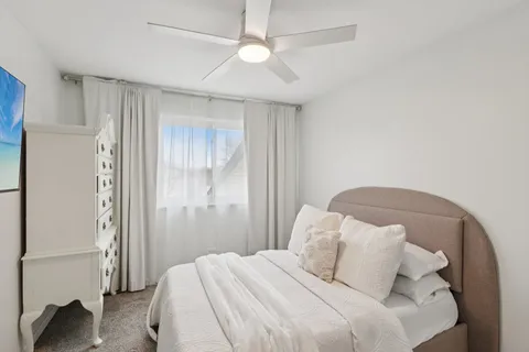 a bedroom with a bed and a chandelier