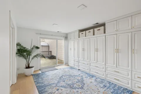 a view of a livingroom with wooden floor and a rug