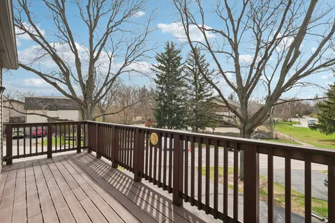 a balcony with wooden floor and fence