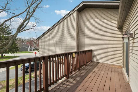 a view of a balcony with wooden floor