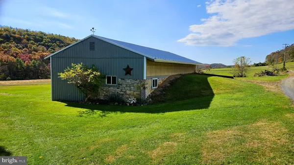 a view of a house with a yard and sitting area