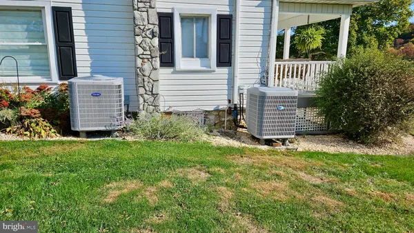 a view of a house with a big yard and potted plants