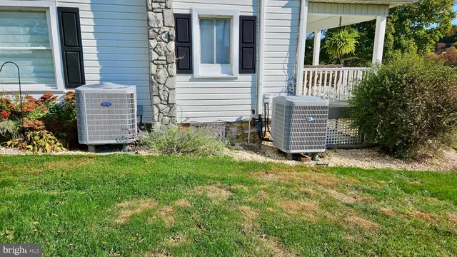 a view of a house with a big yard and potted plants