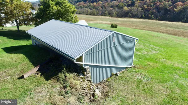 a bathroom with a granite countertop sink a toilet a mirror a vanity and shower