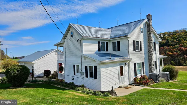 a view of a white house with a yard
