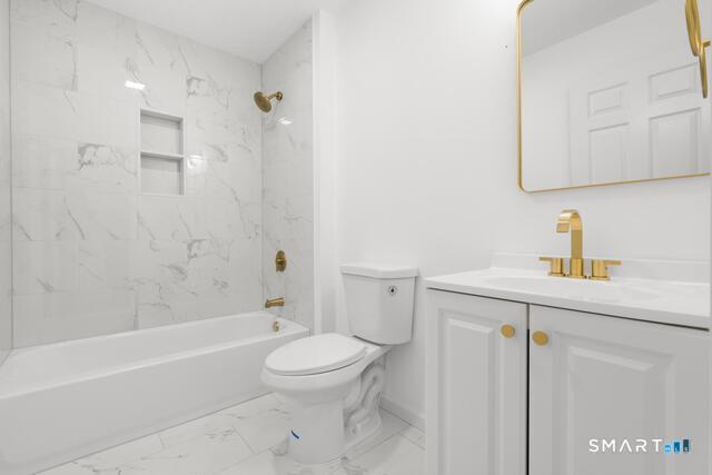 468 Main Street, Unit 318 East Lyme, CT 06357 - Photo 18 of 33 a bathroom with a sink a toilet and shower