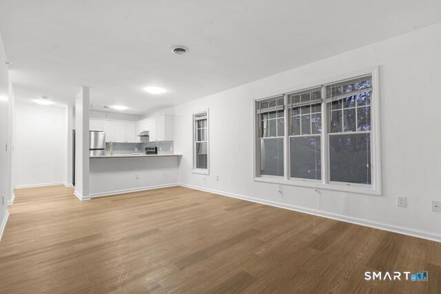 468 Main Street, Unit 318 East Lyme, CT 06357 - Photo 26 of 33 a view of an empty room with a kitchen
