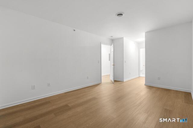 468 Main Street, Unit 318 East Lyme, CT 06357 - Photo 31 of 33 a view of an empty room and wooden floor