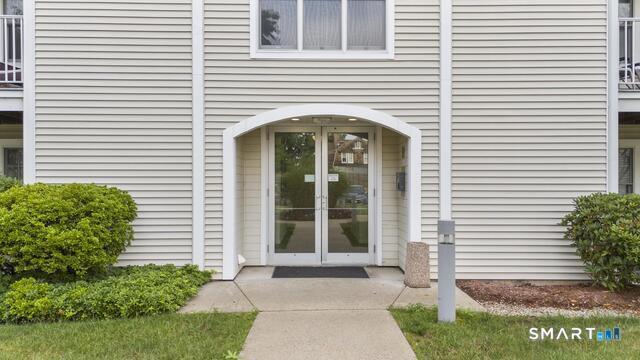 468 Main Street, Unit 318 East Lyme, CT 06357 - Photo 7 of 33 a front view of a house with a porch