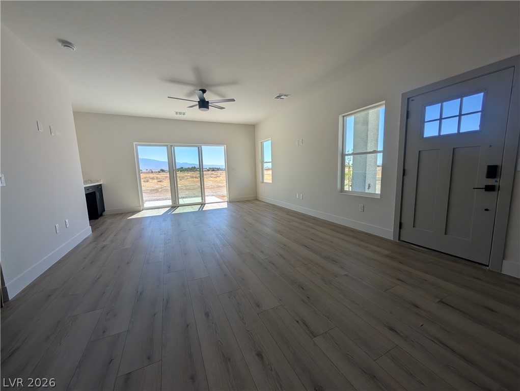 4670 Medicine Man Road Pahrump, NV 89048 - Photo 15 of 36 Natural light streams into this versatile living area, complete with a functional ceiling fan.