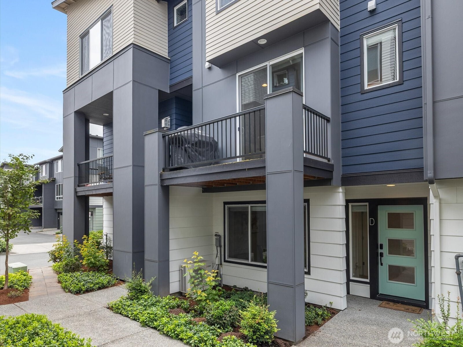 a front view of the house with a garden