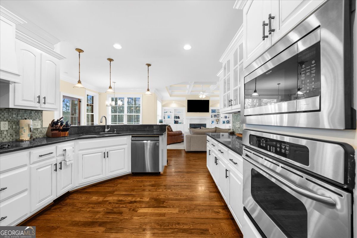 39 Fieldstone Drive Northeast Rome, GA 30161 - Photo 19 of 56 a large kitchen with stainless steel appliances kitchen island granite countertop a large stove a sink dishwasher and white cabinets with wooden floor