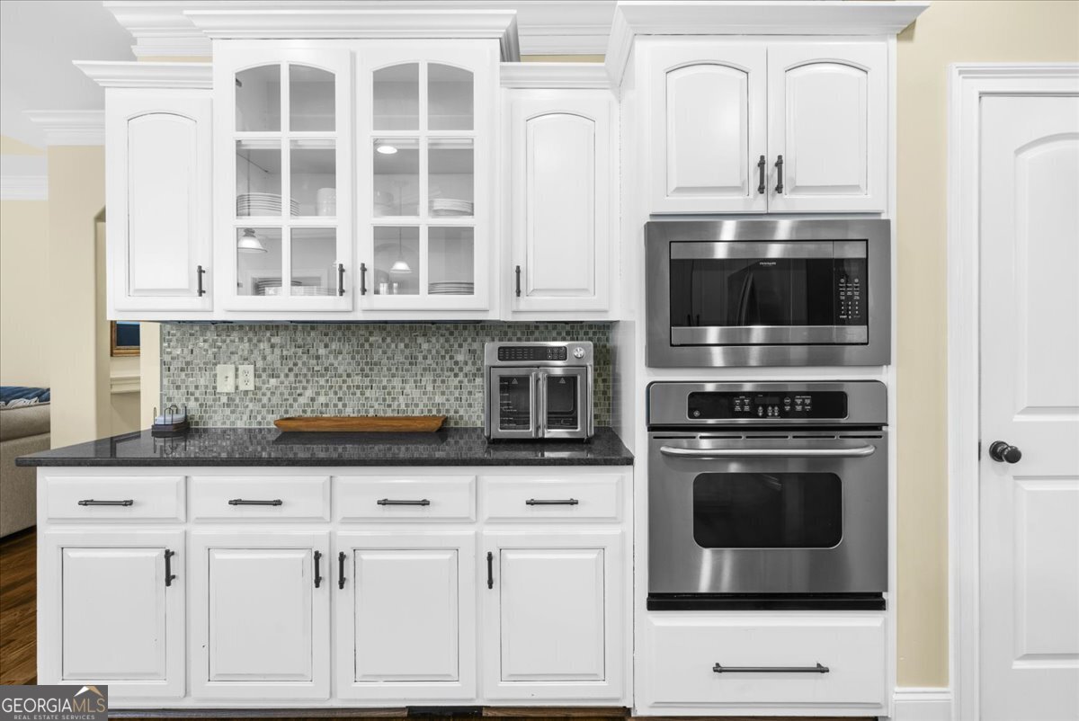 39 Fieldstone Drive Northeast Rome, GA 30161 - Photo 22 of 56 a kitchen with white cabinets and stainless steel appliances