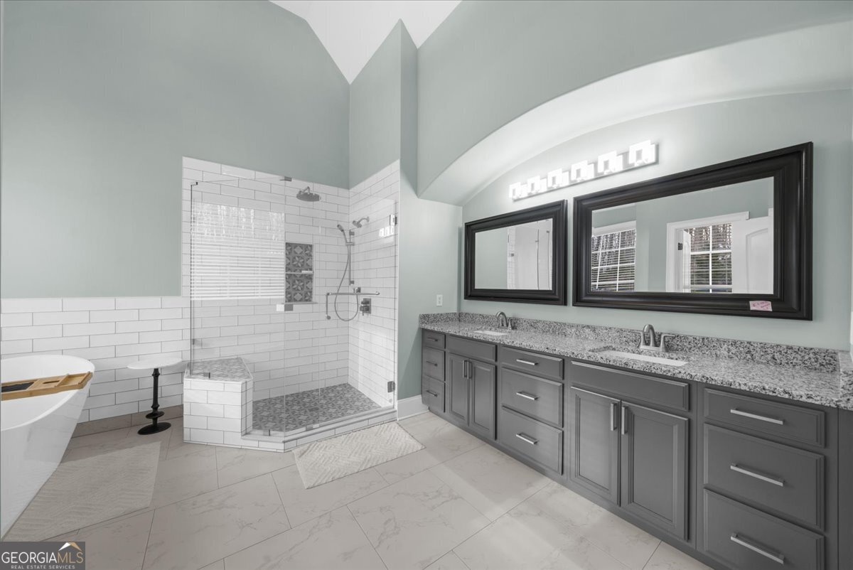 39 Fieldstone Drive Northeast Rome, GA 30161 - Photo 33 of 56 a spacious bathroom with a granite countertop sink a toilet a mirror and bathtub
