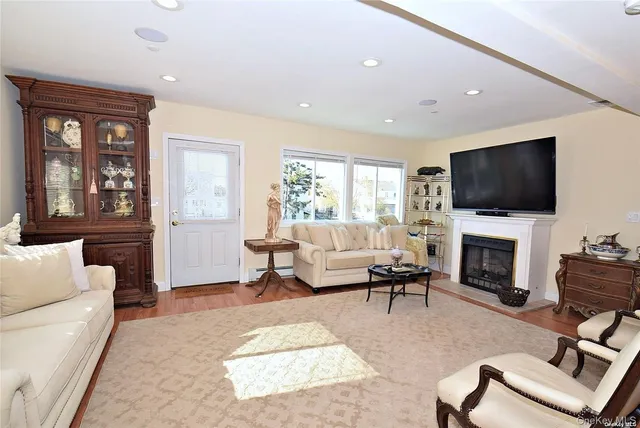 a living room with furniture a fireplace and a flat screen tv