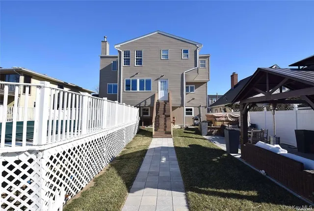 a view of a brick house with wooden fence
