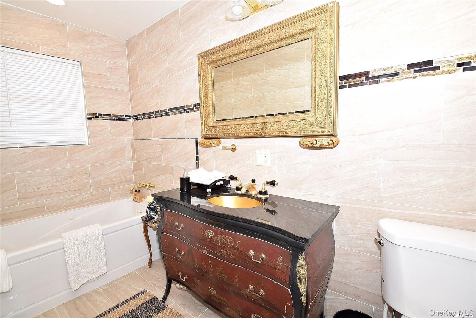 3434 Colony Drive Baldwin, NY 11510 - Photo 7 of 21 a bathroom with a sink mirror vanity and toilet