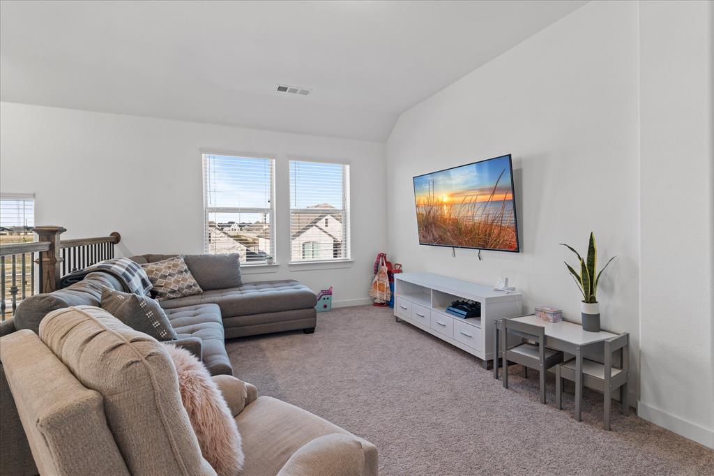 1332 Thompson Road Argyle, TX 76226 - Photo 23 of 36 Living room featuring light carpet and lofted ceiling