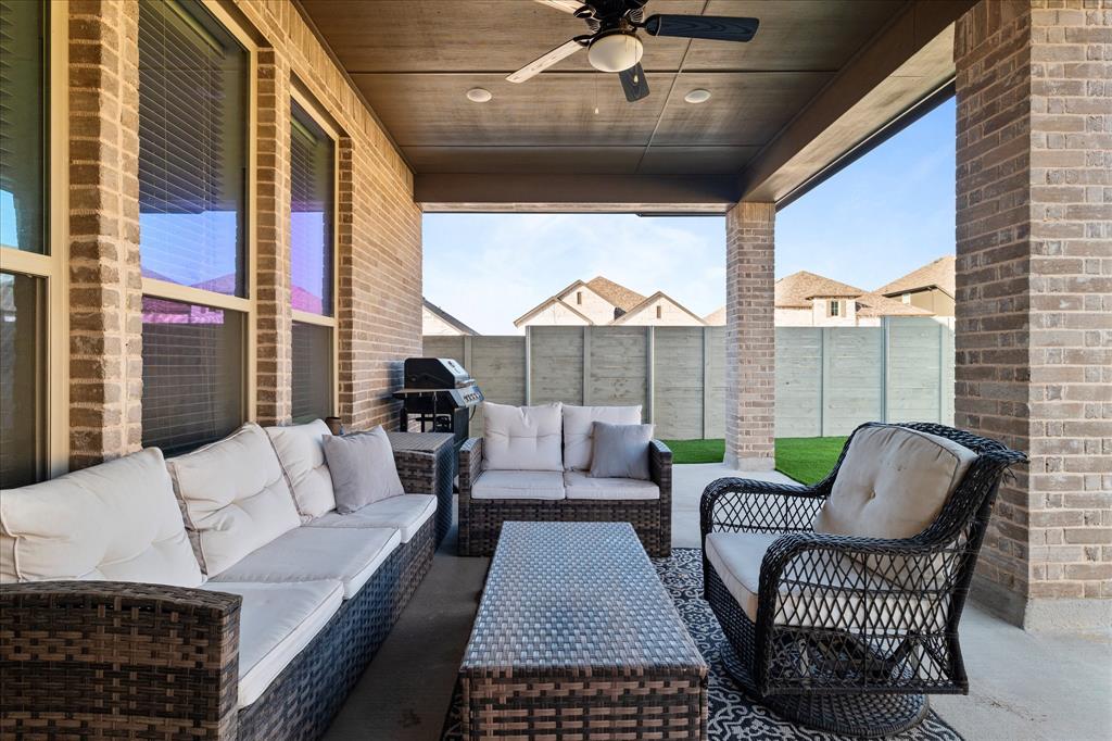 1332 Thompson Road Argyle, TX 76226 - Photo 29 of 36 Fenced backyard with ceiling fan, a patio area, a grill, and an outdoor lounge area